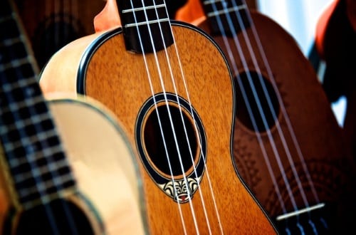 Some Ukuleles hanging on a wall.